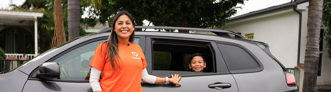 HopSkipDrive driver and passenger smiling